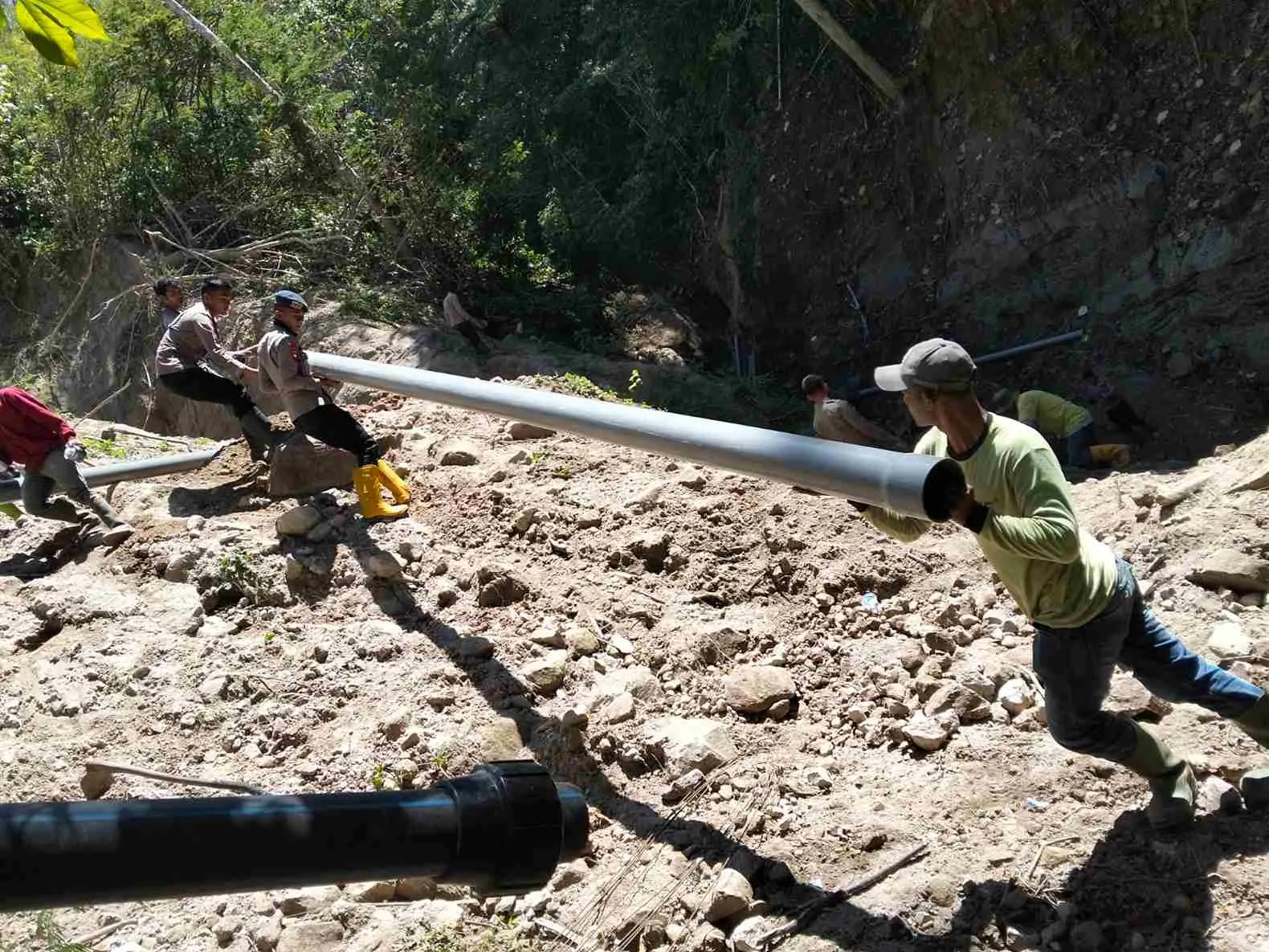 Polsek Ketol Bersama Brimob Gotong Royong Perbaiki Pipa Air Rusak Akibat Longsor